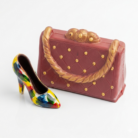 Colorful high-heeled shoe and pink handbag with gold accents on a white background